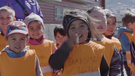 Adorable-Kids-In-Uniform-Enjoying-Their-Day-Outdoors-In-Paarsisoq-Day-Care-Center-In-Nuuk,-Greenland---Close-Up-Shot