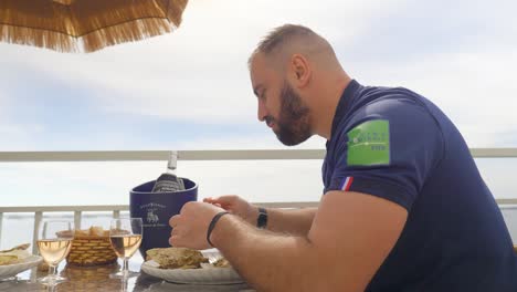 A-man-enjoys-seafood-on-an-outdoor-terrace-in-Meze
