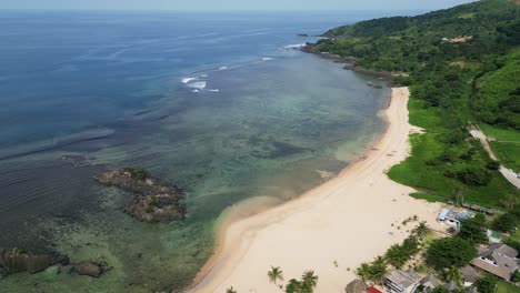 Establishing-aerial-drone-shot-of-a-peaceful-tropical-island-coastline-with-a-white-sand-beach-and-transparent-reef-in-Catanduanes,-Philippines