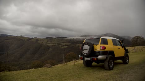 Yellow-car-admiring-the-view-of-Barrington-Tops-National-Park-during-a-snowstorm