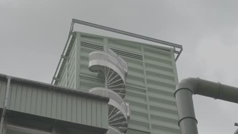 Spiral-Staircase-On-Side-Of-Sile-Building