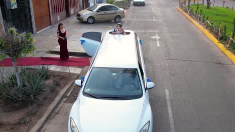 Aerial-view-of-girls-getting-into-a-white-limousine-and-coming-out-from-the-roof-during-her-birthday-celebration