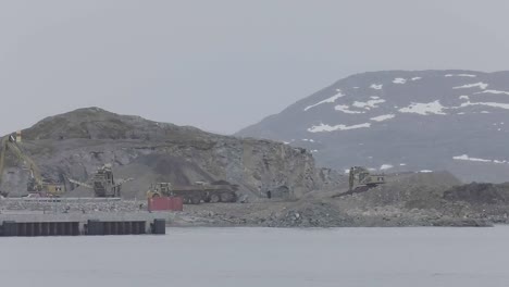 View-Across-Waters-In-Greenland-Of-Heavy-Machinery-At-Rock-Quarry