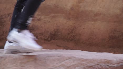 Tourist-walking-through-Petra-Jordan-in-white-Nike-Air-Max-trainers