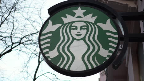 A-Starbucks-logo-filmed-outside-on-a-shopping-street-in-Vienna,-Austria