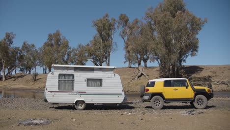 Yellow-car-with-caravan-camping-at-Ponto-Falls-Reserve