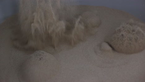 Close-up,-slow-motion-scene-of-fine-sand-being-thrown-into-the-air-which-is-used-for-industrial-purposes