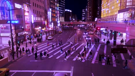 Zukunftsaussehende-Menschen,-Die-Nachts-Mit-Leuchtreklamen-Eine-Stadtstraße-überqueren