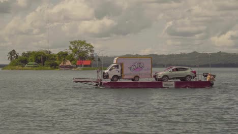 Small-ferry-boat-carrying-cars-through-a-lake-durinf-the-day
