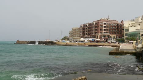 Waves-Crashing-On-The-Port-Of-Marsalforn,-Gozo