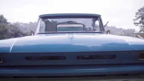 Close-up-of-a-blue-grill-of-a-Chevrolet-vintage-blue-pick-up-truck