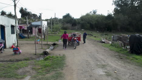 Neighbors-buying-milk-in-a-poor-rural-village,-South-America