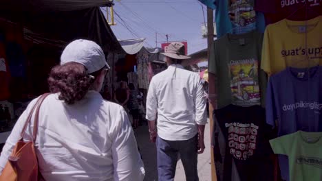 People-walking-through-the-Chichi-market-in-Guatemala,-slow-motion