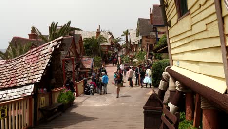 Tourists-Walking-On-The-Street-In-Popeye-Village-On-A-Windy-Day