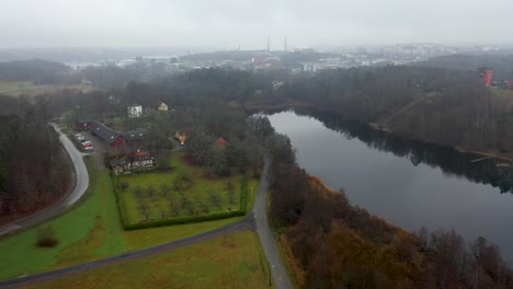 Aerial-footage-over-a-lake-located-in-a-nature-park-beside-Stockholm-University