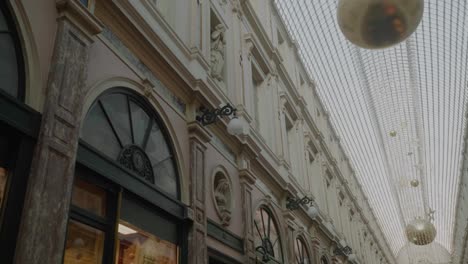 Ornate-Facade-of-Galeries-Royale-St-Hubert,-Glass-Ceiling,-Festive