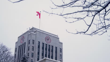 A-RIGHT-TO-LEFT-CLOSEUP-DOLLY-SHOT-of-a-Snowy-Vancouver-City-Hall-on-a-Cold-Overcast-Day