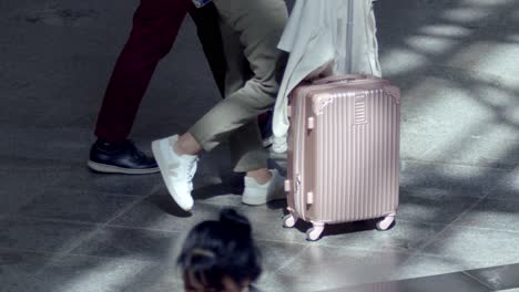 Unrecognizable-people-pulling-luggage-at-the-airport-in-slow-motion