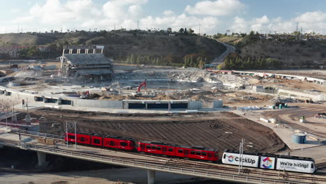 Aerial-of-nearly-complete-demolition-of-Qualcomm-stadium-in-San-Diego-with-trolley-in-foreground