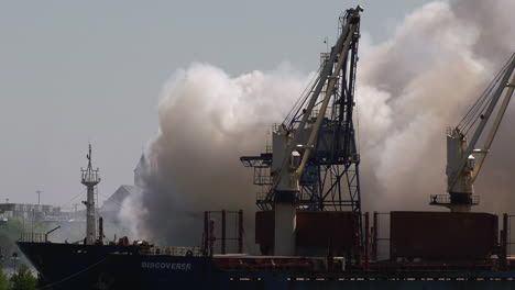 Billowing-smoke-behind-a-large-ship