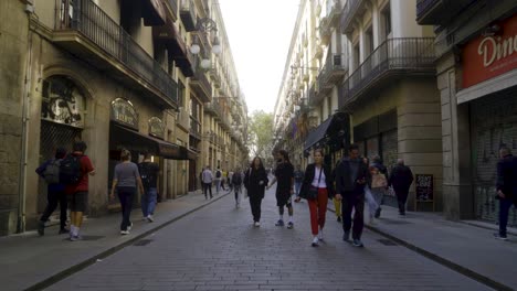 Forward-time-lapse-hyperlapse-through-long-central-street-in-Barri-Gothic-quarter-of-Barcelona-with-people-starting-their-day-in-the-morning
