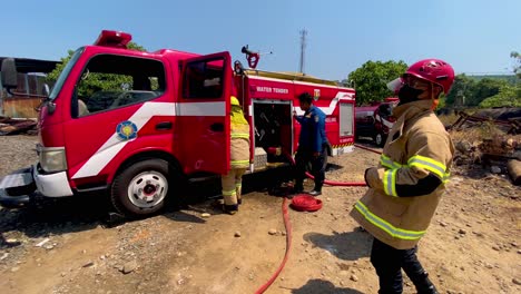 Firefighters-of-Indonesia-preparing-hose-at-accident-location,-slow-motion-view