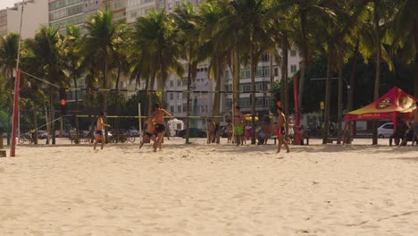 Gruppe-Brasilianischer-Männer,-Die-Bei-Sonnenlicht-Beachvolleyball-Am-Strand-Von-Ipanema-In-Rio-De-Janeiro-Spielen
