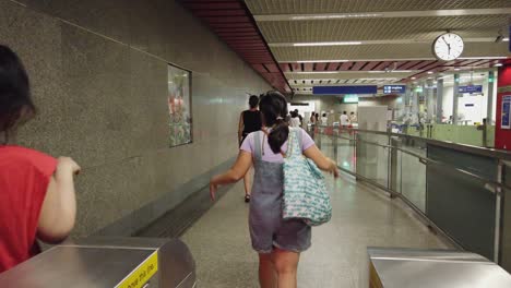 POV:-Thai-people-pass-turnstiles-leading-into-Bangkok-subway-station