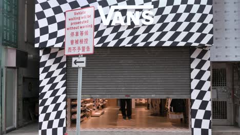 Pedestrians-walk-past-the-multinational-sports-clothing-brand-Vans-store-about-to-open-to-the-public
