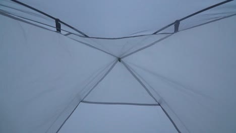 Tilt-Shot-Of-Camper-Setting-Tent-For-Camping-In-Lima-Desert,-Peru