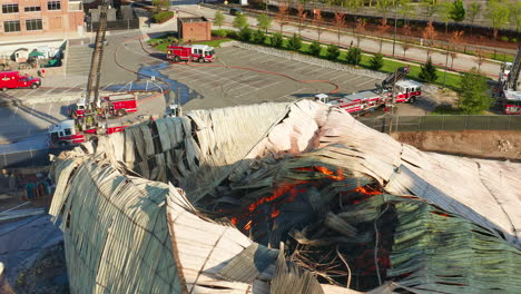 Aerial-shot-above-collapsed-and-burning-sugar-storage-facility