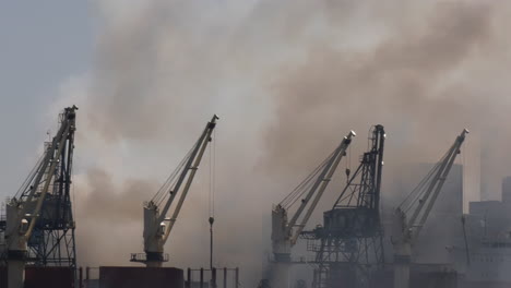 Fire-billowing-from-burning-sugar-factory-with-ships-in-the-foreground