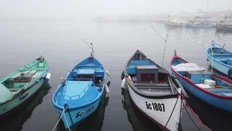 Empty-fishing-boats-in-the-Sarafovo-port,-sway-on-the-waves