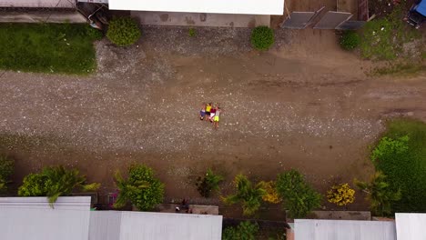 Overhead-Shot-Of-Kids-Laying-Down-On-Ground-Posing-For-Drone-Shot,-Huicungo,-Peru