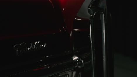 Detail-shot-of-the-logo-of-a-red-Cadillac-Deville