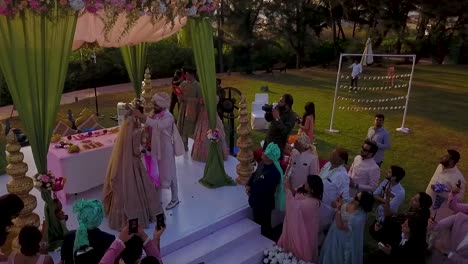 A-drone-view-of-bride-and-groom-putting-garland-on-each-other-at-Kenilworth-in-South-Goa,-India