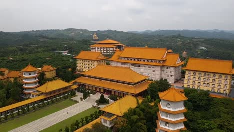 Drone-aerial-forward-flying-view-of-Fo-Guang-Shan-Buddha-Museum-complex-on-cloudy-day