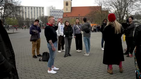 Walkative-Tour-Guide-Talking-And-Explaining-To-Tour-Group-About-Berlin-Beside-The-Neptune-Fountain