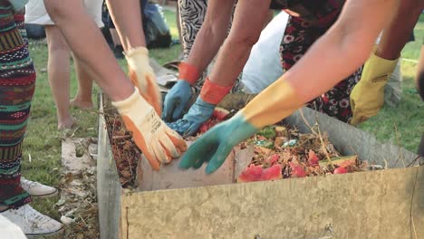Team-of-neighbors-making-a-compost-bin,-close-up-of-hands