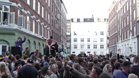 Young-festival-and-party-goers-enjoy-life-at-an-open-air-street-party-dancing-together-united-as-friends