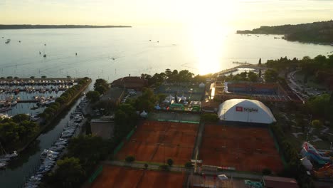 Drone-aerial-forward-moving-flying-view-of-Portoroz-town-in-yellow-sunset-light,-Slovenia
