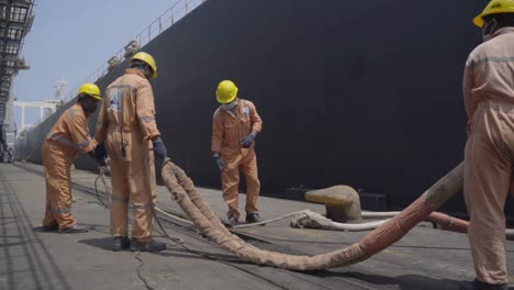 Dockers-Untangling-Hawser-Of-A-Huge-Ship-At-The-Port