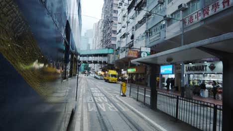 Side-View-Of-A-Blue-Double-Decker-Bus-Travelling-On-The-Road-In-Hong-Kong---Timelapse