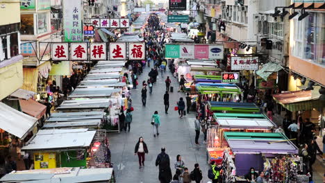 Many-People-Walking-Down-The-Streets-Where-Several-Stalls-Lining-Up-During-A-Festival-In-Hong-Kong---Timelapse