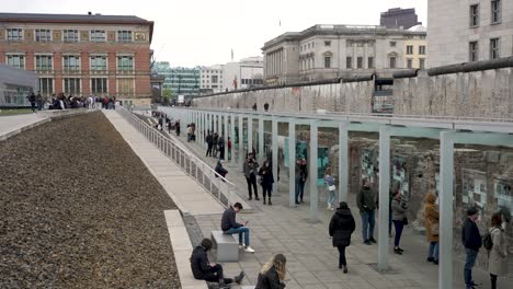 Tourists-Walking-Along-Outdoor-Exhibition-At-Topography-Of-Terror-In-Berlin