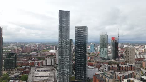 Establishing-aerial-view-across-tall-geometric-Deansgate-Manchester-downtown-cityscape-skyscrapers-and-city-centre-skyline
