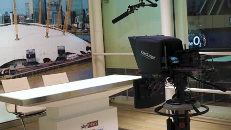 Empty-news-desk-and-teleprompter-at-the-Sky-TV-television-studio
