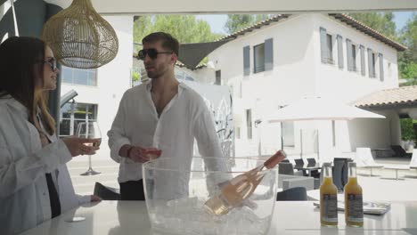 People-are-standing-in-front-of-the-luxurious-villa-in-south-of-France-and-drinking-wine