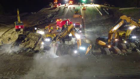 Demolition-works-on-Sunnivale-bridge-over-Highway-400-in-Barrie,-heavy-Machinery-at-Night,-Canada
