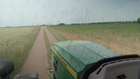 Inside-View-From-Tractor-With-View-Of-Bonnet-Driving-Down-Farm-Road